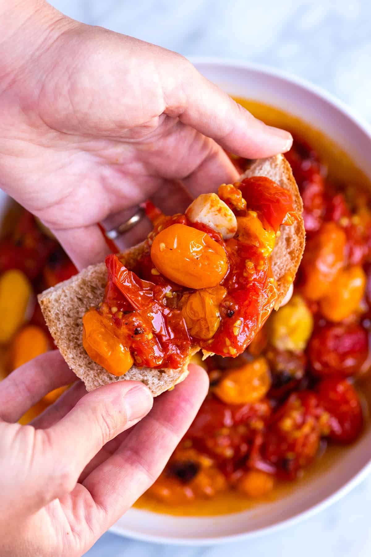 Oven Roasted Tomatoes spread onto a slice of bread