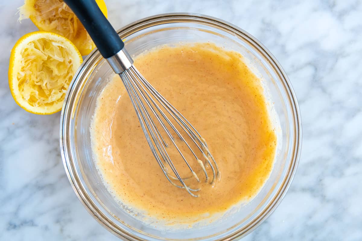 Whisking tahini dressing ingredients together