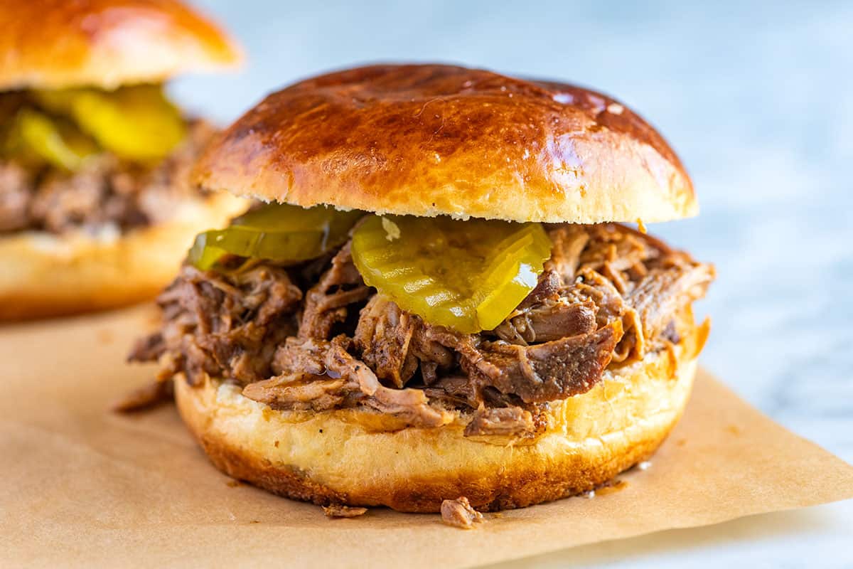 Pulled Pork on a sandwich bun with pickles