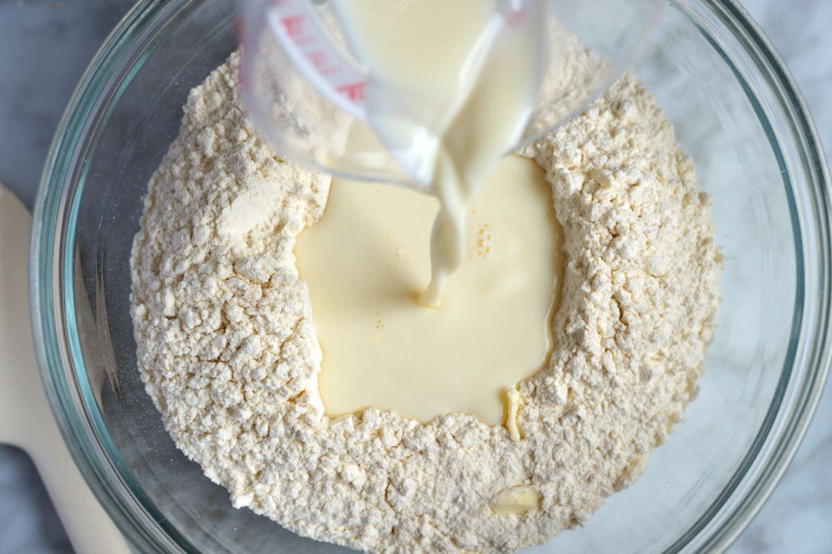 Adding milk to the biscuit dough