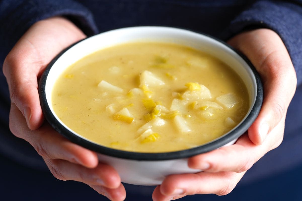 Holding a bowl of homemade potato leek soup