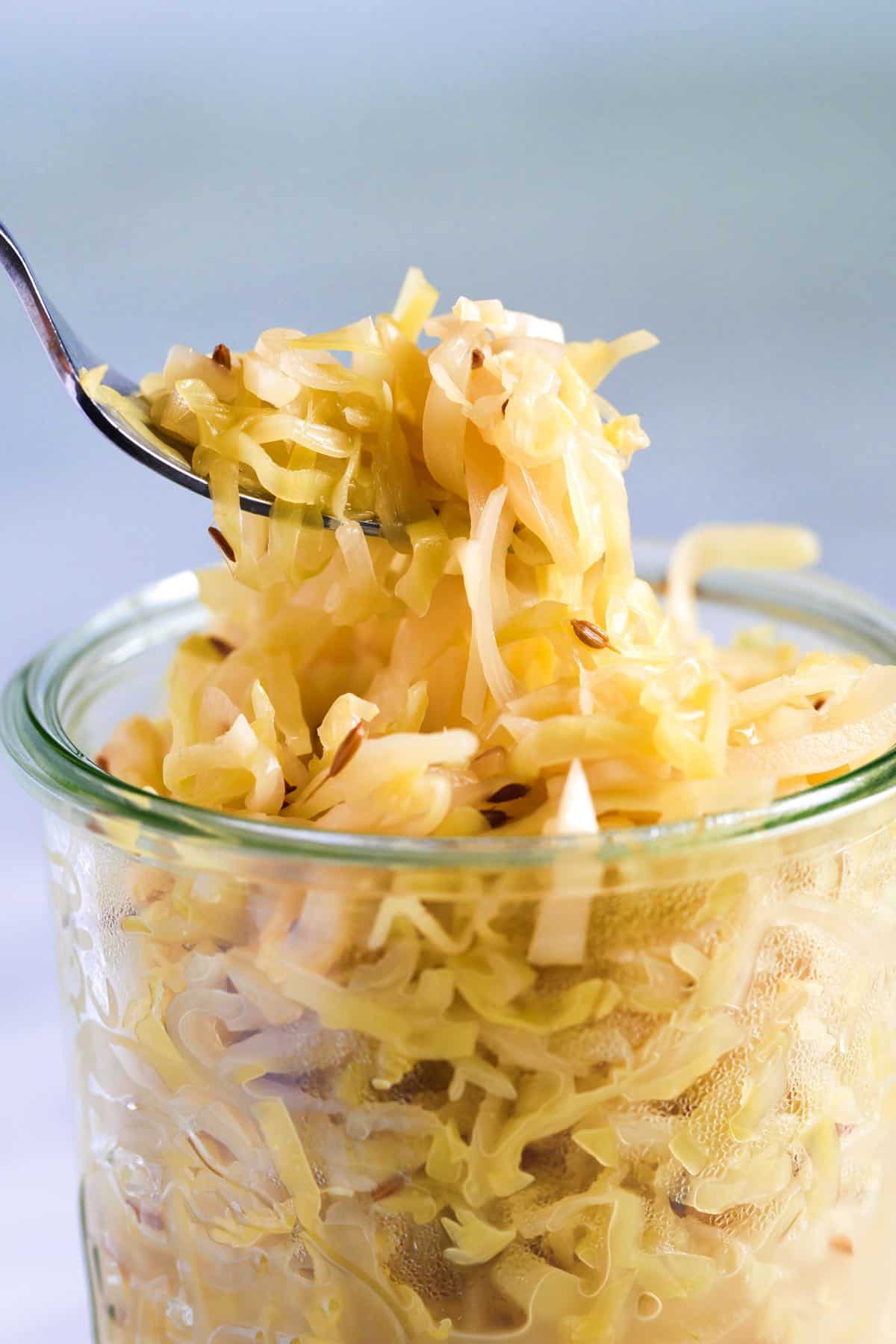 A jar of homemade sauerkraut with caraway seeds