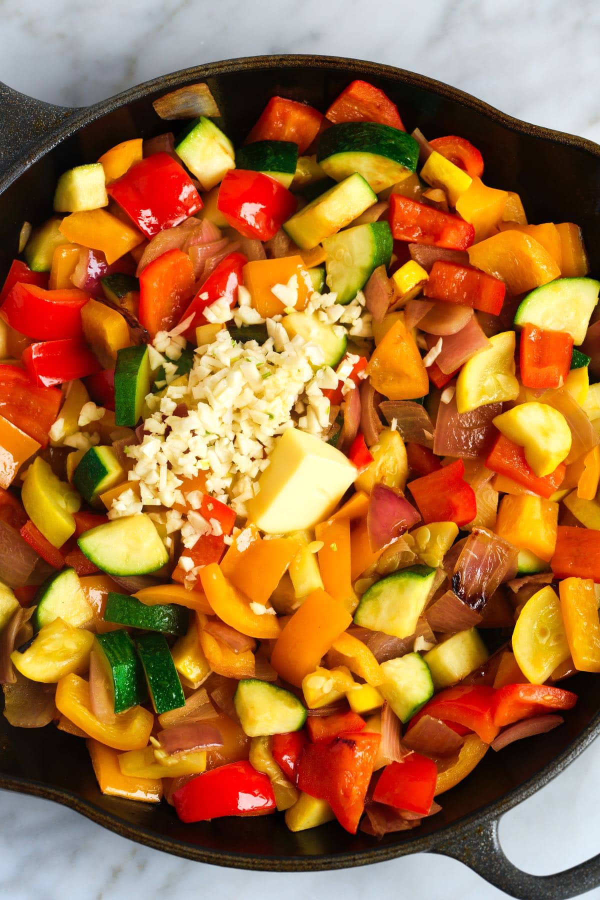 How to Make Sauteed Vegetables: Adding garlic and butter to the vegetables