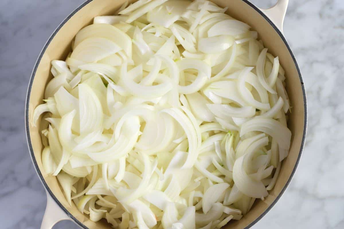 Cooking onions for french onion soup step 1 -- heaping pile of sliced onions