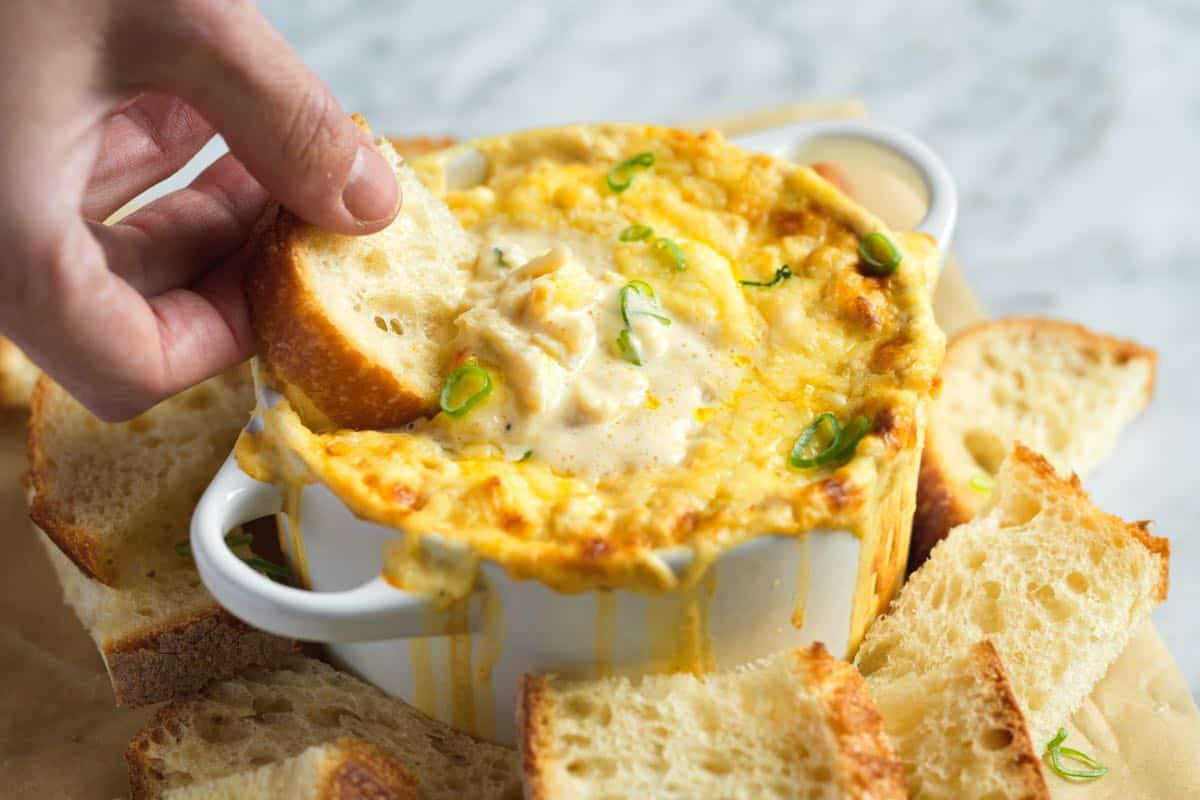 Dipping bread into Homemade Crab Dip
