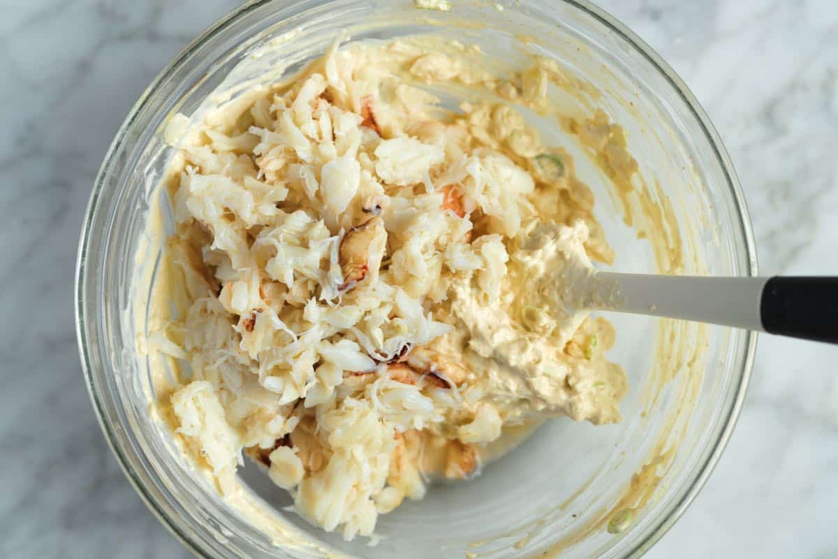 Folding crabmeat into the dip ingredients.