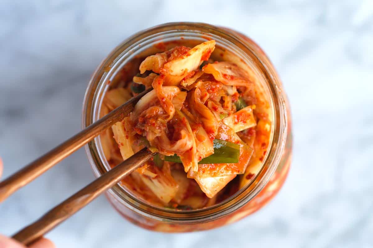 Pulling kimchi out of a jar