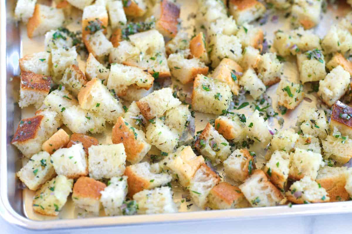 Bread cubes on a baking sheet ready to go into the oven for croutons