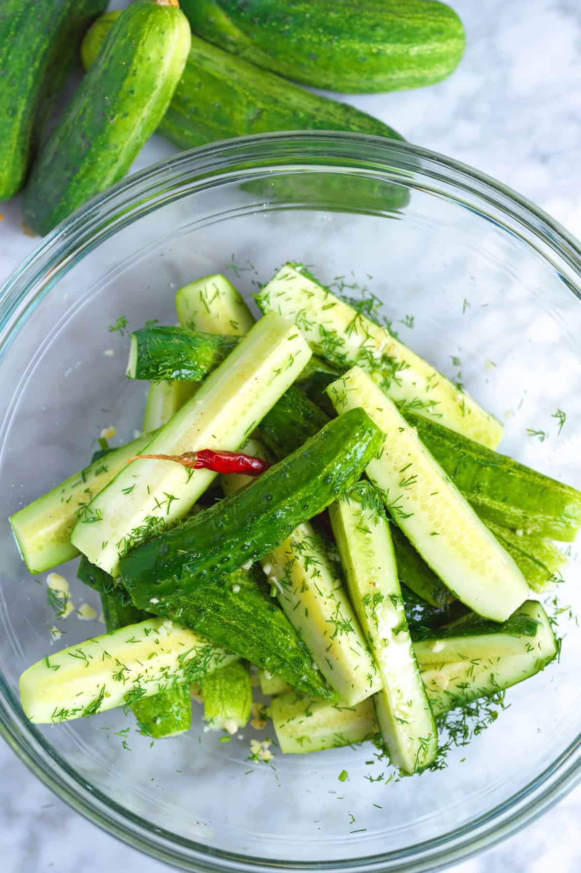 Cucumbers with salt, peppercorns, and dill ready for pickling