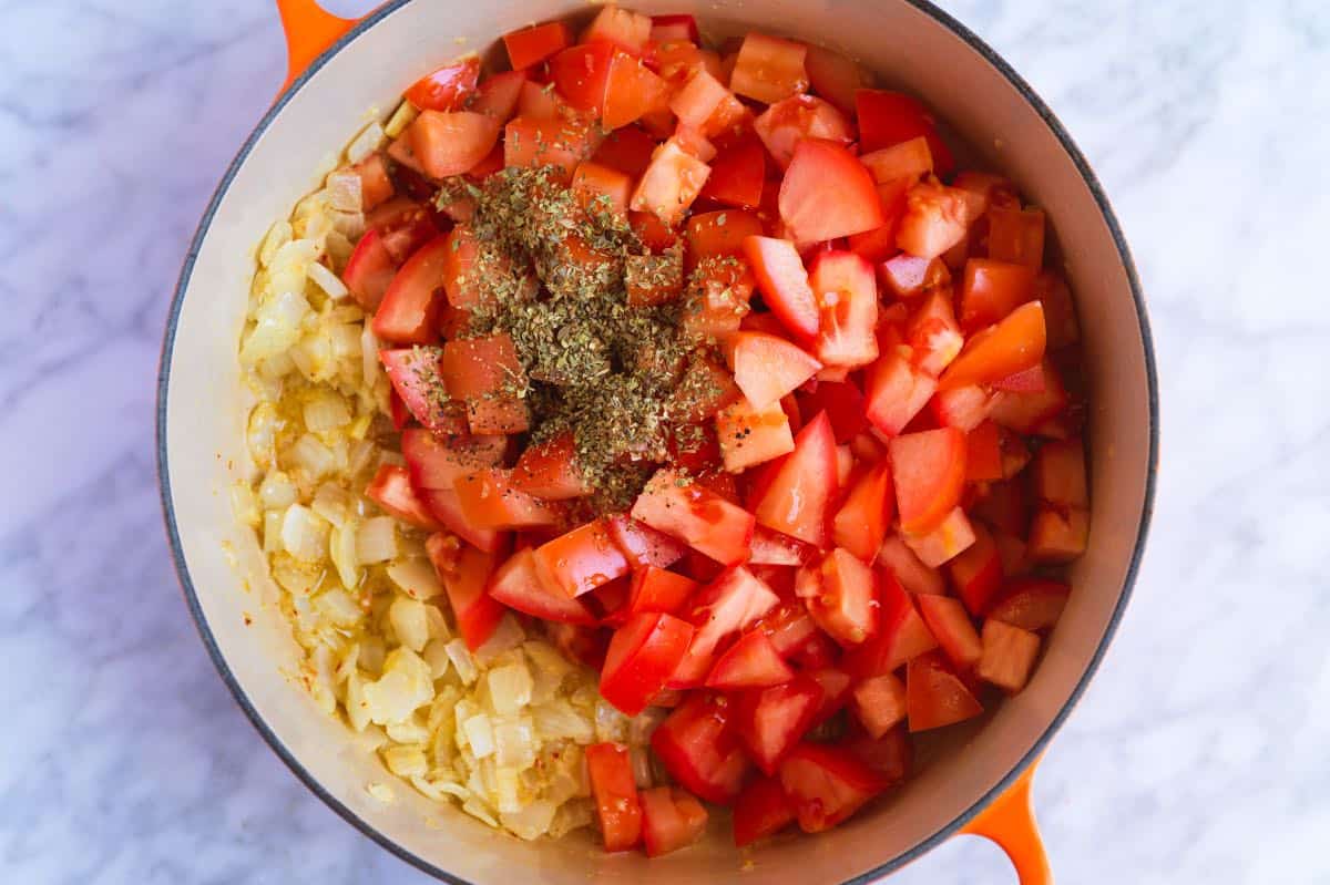 Making pizza sauce with fresh tomatoes and garlic.