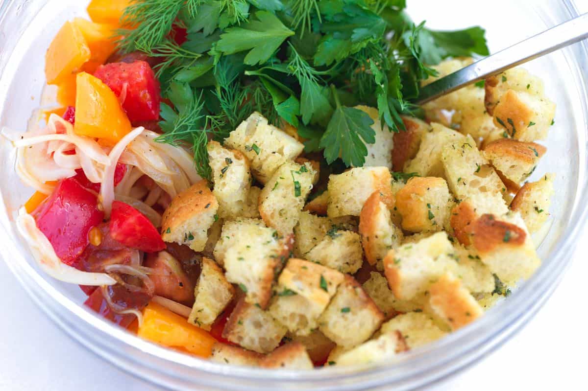 Assembling panzanella salad