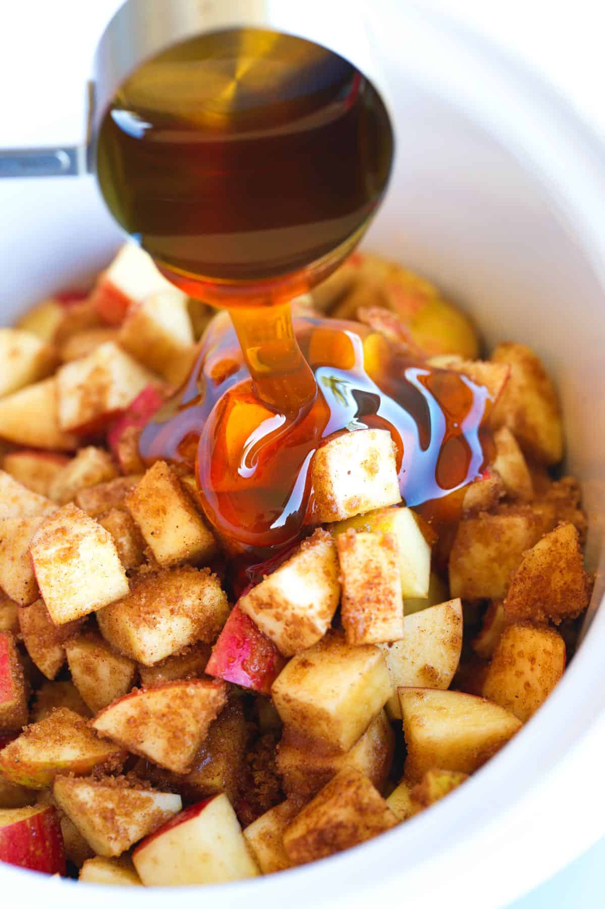 Adding honey to the apples in the slow cooker