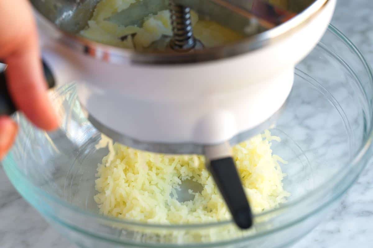 Using a food mill for the potatoes