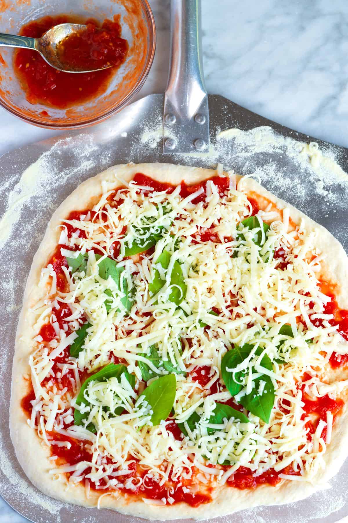 Making Margherita pizza with authentic sauce and mozzarella