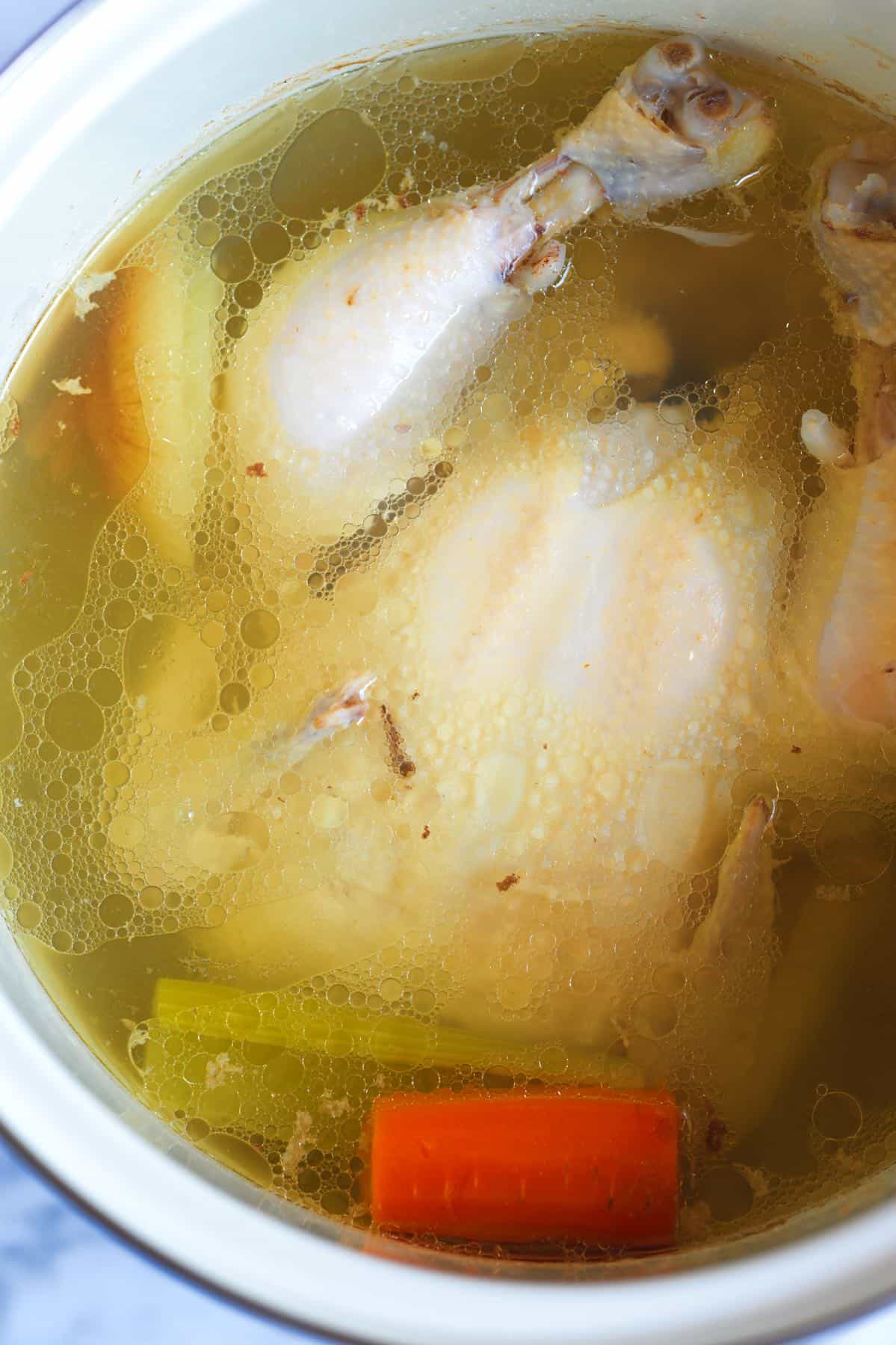 Making homemade chicken broth and chicken for chicken and dumplings from scratch