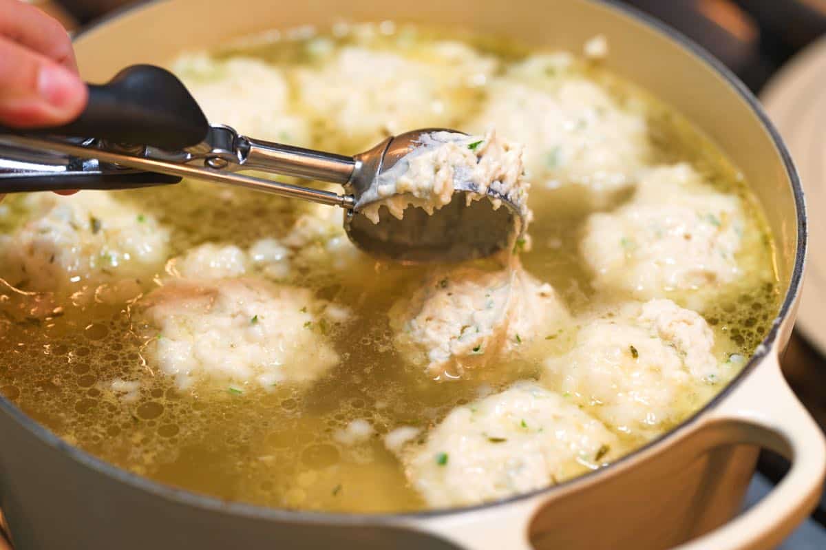 Dropping dumpling batter into chicken soup