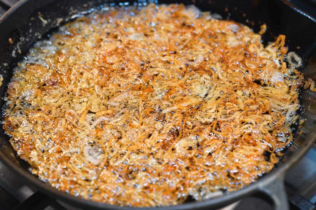 How to Make Fried Shallots: fried shallots almost ready to come out of the oil