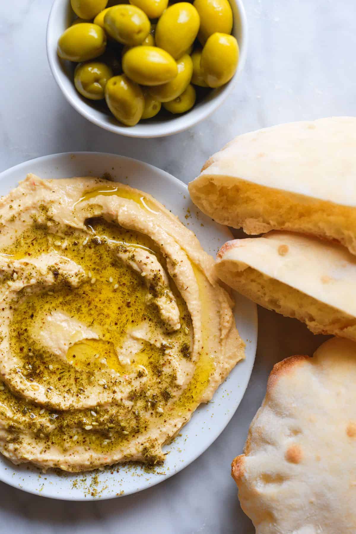 Homemade pita bread with hummus and olives