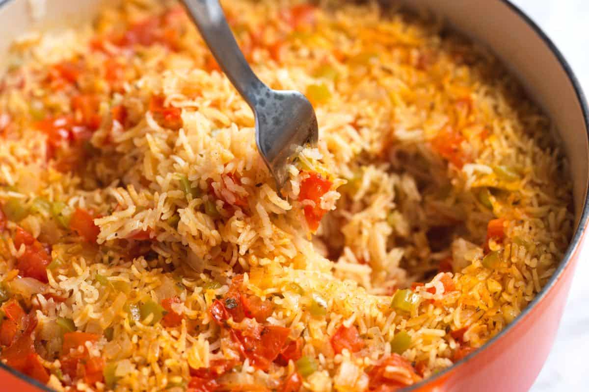 Fluffing cooked Mexican rice (aka Spanish rice) with a fork before serving
