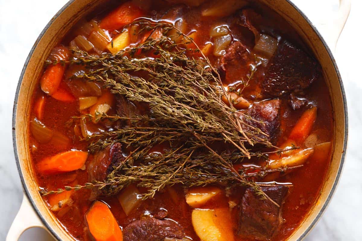 Beef stew simmered to perfection - tender beef, vegetables, and rich gravy with fresh thyme (thyme removed before serving)