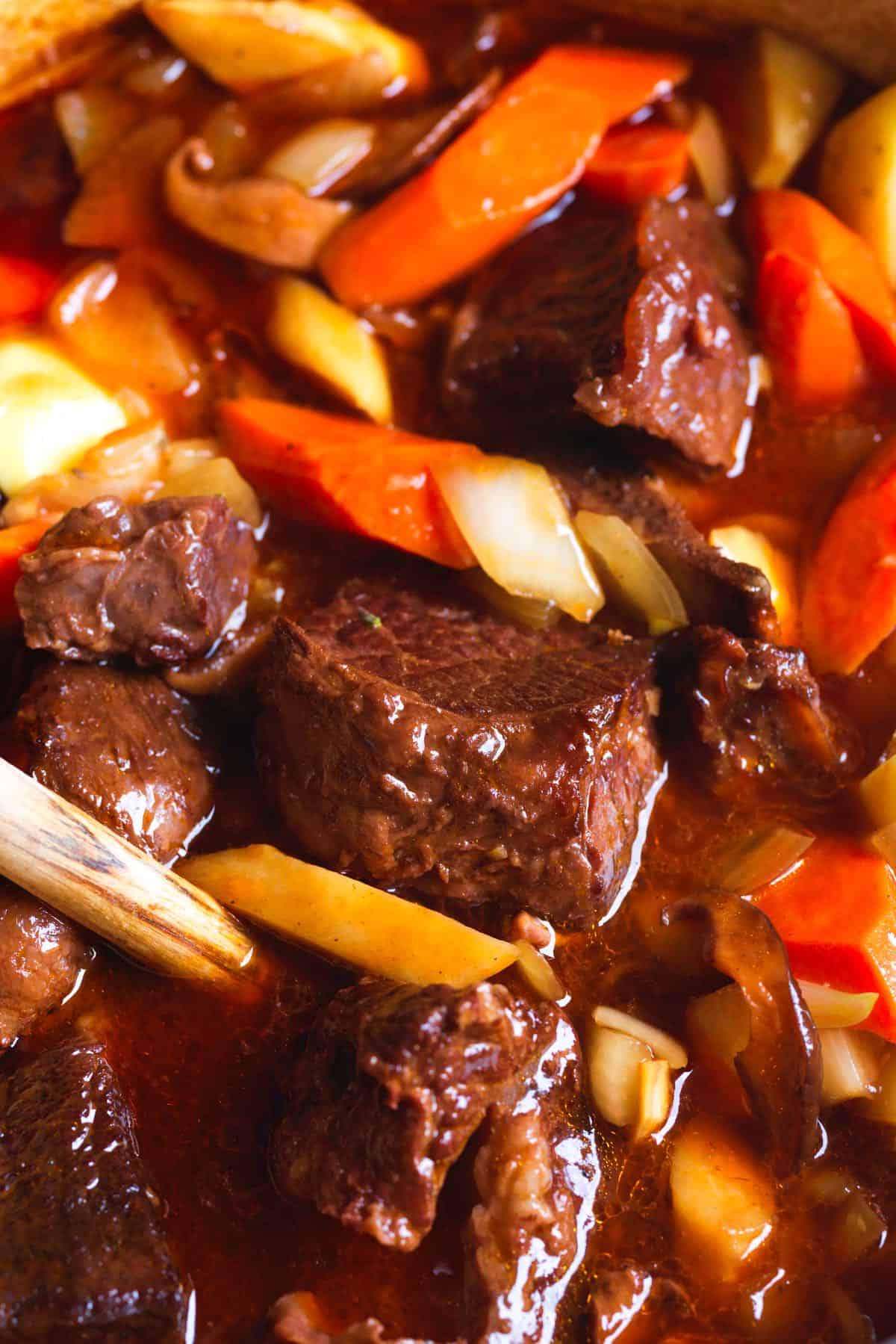 Beef stew close-up - showcasing tender beef, potatoes, carrots, and mushrooms.