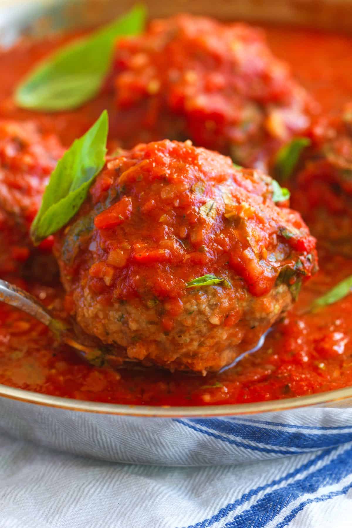 Authentic Italian meatballs cooked with Italian herbs and a tomato sauce.
