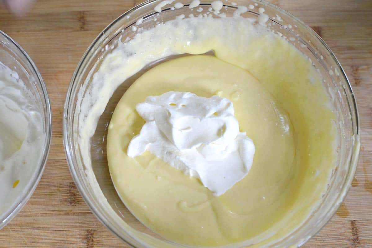 How to make tiramisu - Folding the whipped cream into the mascarpone and Zabaglione mixture.