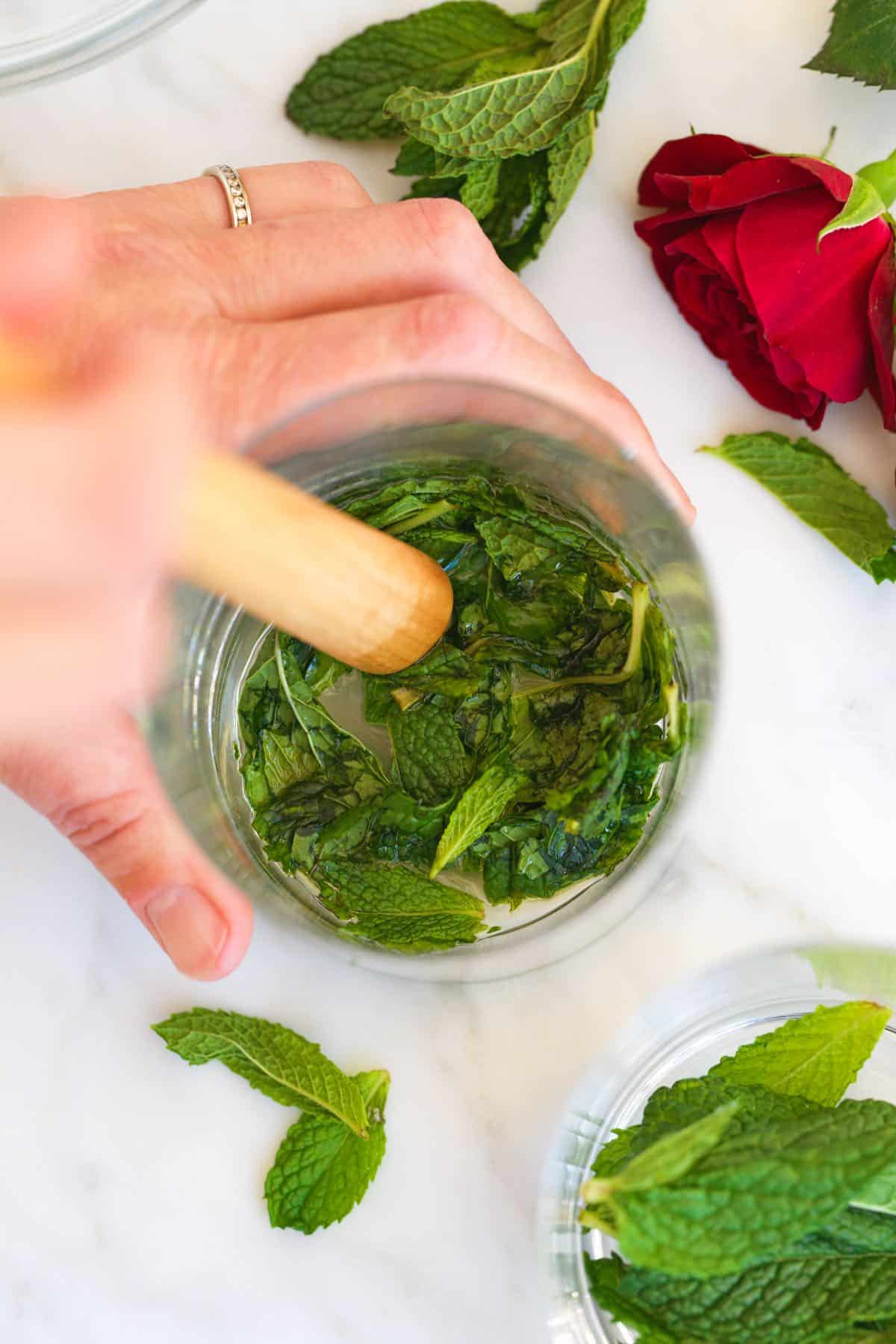 How to Make a Mint Julep - Muddling fresh mint with simple syrup